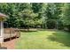 Lush backyard with a spacious lawn, covered parking, and mature trees at 280 Ridgemont Dr, Fayetteville, GA 30215