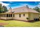 Exterior side view of the home with a screened in porch and lush green yard at 280 Ridgemont Dr, Fayetteville, GA 30215