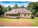 Exterior rear view of home featuring screened in porch and a large yard at 280 Ridgemont Dr, Fayetteville, GA 30215