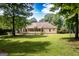 Expansive backyard featuring a lush lawn and a charming home with a screened-in porch and a wooden deck at 280 Ridgemont Dr, Fayetteville, GA 30215
