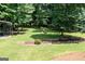 Exterior view of backyard featuring lush greenery and outbuildings at 280 Ridgemont Dr, Fayetteville, GA 30215