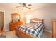 Comfortable bedroom features a checked comforter, wood furniture, and a ceiling fan at 280 Ridgemont Dr, Fayetteville, GA 30215