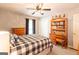 Bright bedroom featuring a ceiling fan, light colored walls, and dark window coverings at 280 Ridgemont Dr, Fayetteville, GA 30215