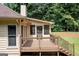 View of the outdoor deck area that connects to the screened in porch and backyard at 280 Ridgemont Dr, Fayetteville, GA 30215