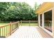 Wooden deck overlooking a lush green backyard with mature trees and privacy fencing at 280 Ridgemont Dr, Fayetteville, GA 30215