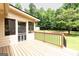 Elevated wooden deck adjoins the screened porch offering outdoor living space and backyard views at 280 Ridgemont Dr, Fayetteville, GA 30215