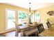 Bright dining area with large windows, hardwood floors, and a wooden dining table with seating for six at 280 Ridgemont Dr, Fayetteville, GA 30215