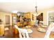Open-concept dining area with a view of the kitchen, pot rack, and stainless steel refrigerator at 280 Ridgemont Dr, Fayetteville, GA 30215