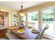 Comfortable dining area featuring a wooden table, bench seating, and views to an adjacent living area at 280 Ridgemont Dr, Fayetteville, GA 30215