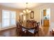 Bright dining room with hardwood floors, a chandelier, and a view into the kitchen at 280 Ridgemont Dr, Fayetteville, GA 30215