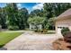 Long driveway leading to home with lush green yard and surrounding mature trees at 280 Ridgemont Dr, Fayetteville, GA 30215