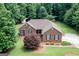Charming brick home with well-maintained landscaping and a sprawling green lawn at 280 Ridgemont Dr, Fayetteville, GA 30215