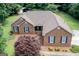 Brick home featuring tidy landscaping, large yard, and a cozy front porch at 280 Ridgemont Dr, Fayetteville, GA 30215
