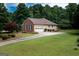 Side of a brick home with attached garage, large yard and well-maintained landscaping at 280 Ridgemont Dr, Fayetteville, GA 30215