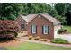 Side view of a brick home featuring manicured landscaping and an attached garage at 280 Ridgemont Dr, Fayetteville, GA 30215