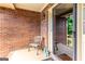 Charming front porch featuring brick walls, a cozy bench, and an inviting entryway at 280 Ridgemont Dr, Fayetteville, GA 30215