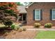 Cozy front porch with brick facade, bench seating, and glass storm door entrance at 280 Ridgemont Dr, Fayetteville, GA 30215