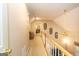 Upstairs hallway with a wooden banister, ceiling fan, bench, and carpet; home office visible in background at 280 Ridgemont Dr, Fayetteville, GA 30215
