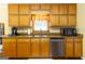 Functional kitchen with stainless steel appliances, wood cabinets, and a double sink at 280 Ridgemont Dr, Fayetteville, GA 30215