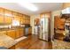 Well-lit kitchen with stainless steel appliances, wood cabinetry, and tile countertops at 280 Ridgemont Dr, Fayetteville, GA 30215