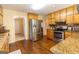 Kitchen features stainless steel appliances, granite counters, and wooden cabinetry at 280 Ridgemont Dr, Fayetteville, GA 30215