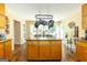 Spacious kitchen with center island, hanging pot rack, wooden cabinets, granite countertops, and hardwood floors at 280 Ridgemont Dr, Fayetteville, GA 30215