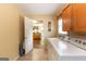 Functional laundry room adjacent to the kitchen area, with a view of the center island at 280 Ridgemont Dr, Fayetteville, GA 30215