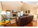 Cozy living room with brick fireplace, vaulted ceiling, and access to the backyard at 280 Ridgemont Dr, Fayetteville, GA 30215