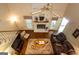 Living room with a brick fireplace, hardwood floors, ceiling fan, and comfortable leather seating at 280 Ridgemont Dr, Fayetteville, GA 30215