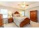 This is a spacious main bedroom featuring a ceiling fan, a dresser, and bedside lamps at 280 Ridgemont Dr, Fayetteville, GA 30215