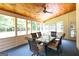 A screened porch with a wooden ceiling, outdoor ceiling fan, and seating area at 280 Ridgemont Dr, Fayetteville, GA 30215