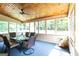 A screened porch with a wooden ceiling and a table with seating for outdoor dining at 280 Ridgemont Dr, Fayetteville, GA 30215