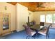 View of a screened in back porch with a patio table, chairs and a light wood ceiling at 280 Ridgemont Dr, Fayetteville, GA 30215