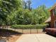 Fenced-in backyard featuring a well-maintained lawn and mature trees at 1209 Persimmon Way, Mcdonough, GA 30252