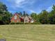 Beautiful two-story brick home with stone accents and a well-manicured lawn at 1209 Persimmon Way, Mcdonough, GA 30252
