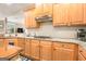 Kitchen featuring granite countertops, stainless steel appliances, and light wood cabinets at 1209 Persimmon Way, Mcdonough, GA 30252