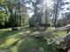 Spacious backyard with lush greenery, and fallen wood at 7128 Lady Heidi Ct, Jonesboro, GA 30236