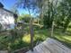 Backyard view with a porch that is partially covered and some trees at 7128 Lady Heidi Ct, Jonesboro, GA 30236