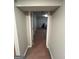 Hallway view showcasing the finished basement with gray laminate flooring at 7128 Lady Heidi Ct, Jonesboro, GA 30236