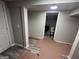 Renovated basement space with gray flooring, showcasing bathroom addition at 7128 Lady Heidi Ct, Jonesboro, GA 30236
