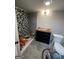 Bathroom during renovation includes a black vanity, mosaic tile shower, and gray floor tiles at 7128 Lady Heidi Ct, Jonesboro, GA 30236