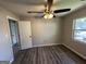 This bedroom boasts gray walls, a ceiling fan, and new wood-look flooring at 7128 Lady Heidi Ct, Jonesboro, GA 30236