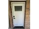A new white door with glass pane is seen from the outside at 7128 Lady Heidi Ct, Jonesboro, GA 30236