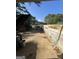 A long driveway leads to a home, with a large dumpster and brick retaining wall at 7128 Lady Heidi Ct, Jonesboro, GA 30236