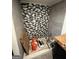 Shower with mosaic tile accent and gray wall tiles is shown during renovation at 7128 Lady Heidi Ct, Jonesboro, GA 30236