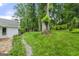 The side of the home showcasing the lush backyard featuring mature trees at 2944 Braithwood Ne Ct, Atlanta, GA 30345