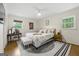 This main bedroom has hardwood floors, natural light, and a large bed with new linens at 2944 Braithwood Ne Ct, Atlanta, GA 30345