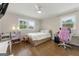 Cozy bedroom featuring hardwood floors, two windows, a ceiling fan, and a full-sized bed at 2944 Braithwood Ne Ct, Atlanta, GA 30345