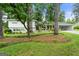 Charming exterior of home with lush landscaping and inviting front porch with wooded trees at 2944 Braithwood Ne Ct, Atlanta, GA 30345