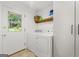 Laundry room with white appliances and a door to the backyard at 2944 Braithwood Ne Ct, Atlanta, GA 30345